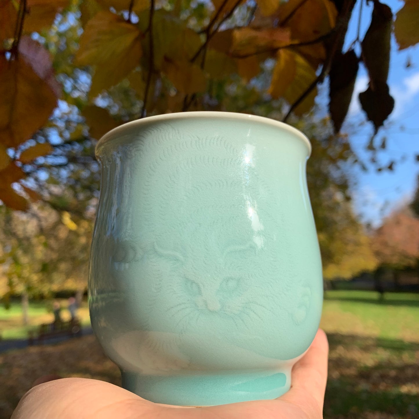 Traditional Chinese Celadon Cup with Hand Carved Cat Pattern